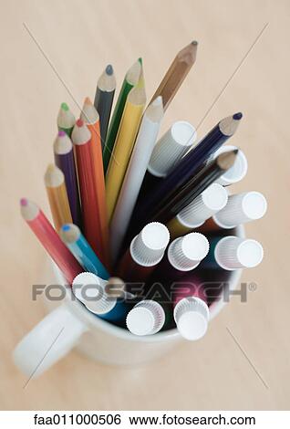 Mug full of colored pencils and markers, high angle view View Large Photo Image Stock Photograph - Mug full of colored pencils and markers, high angle view. Fotosearch