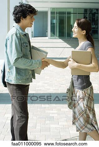Students shaking hands on campus View Large Photo Image Stock Photography - Students shaking hands on campus. Fotosearch