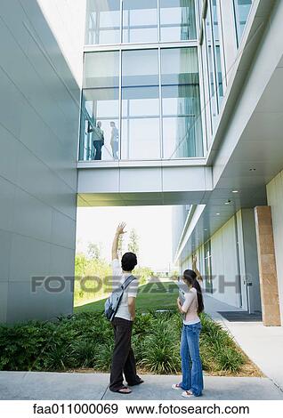 Students waving to each other on campus View Large Photo Image Stock Photo - Students waving to each other on campus. Fotosearch