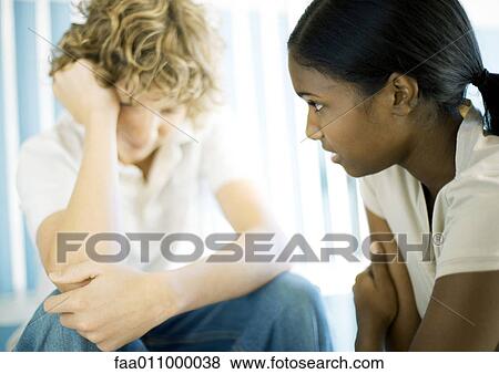 Teen boy and girl having serious conversation View Large Photo Image Stock Photo - Teen boy and girl having serious conversation. Fotosearch