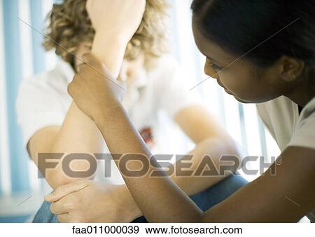 Teen boy sitting with head down, teen girl talking to him View Large Photo Image Stock Photo - Teen boy sitting with head down, teen girl talking to him. Fotosearch