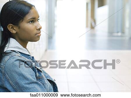 Stock Photo - Teen girl in school hallway. Fotosearch