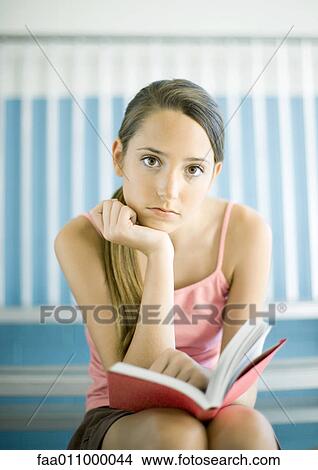 Teen girl reading book on bleachers View Large Photo Image Picture - Teen girl reading book on bleachers. Fotosearch