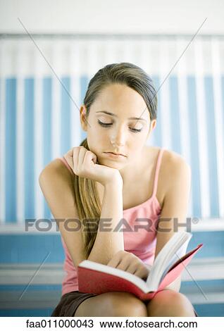 Teen girl reading book on bleachers View Large Photo Image Stock Image - Teen girl reading book on bleachers. Fotosearch