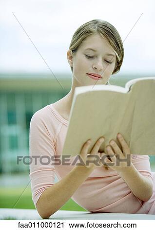 Stock Image - Teen girl reading book. Fotosearch