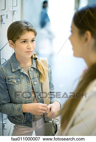 Teen girls standing by lockers View Large Photo Image Stock Photo - Teen girls standing by lockers. Fotosearch