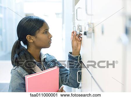 Teenage girl opening locker View Large Photo Image Stock Image - Teenage girl opening locker. Fotosearch