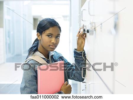 Teenage girl opening locker View Large Photo Image Stock Image - Teenage girl opening locker. Fotosearch