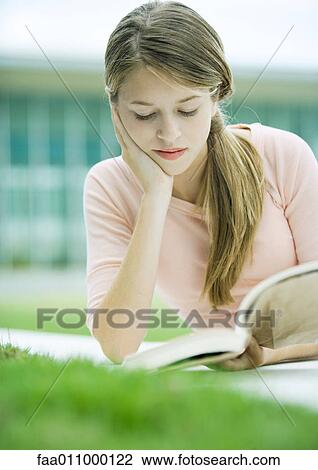 Stock Image - Teenage girl reading book. Fotosearch