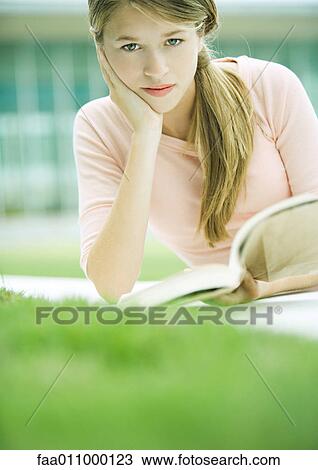 Stock Image - Teenage girl reading book. Fotosearch