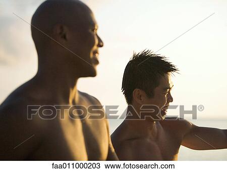Two barchested men on beach at sunset View Large Photo Image Stock Image - Two barchested men on beach at sunset. Fotosearch
