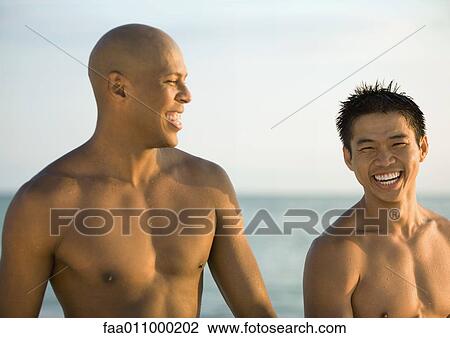 Two barechested men, sea in background View Large Photo Image Stock Image - Two barechested men, sea in background. Fotosearch