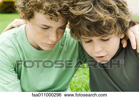 Stock Photograph - Two boys, arms around each other's shoulders. Fotosearch