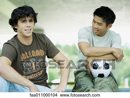 Two male students, one with soccer ball View Large Photo Image Picture - Two male students, one with soccer ball. Fotosearch