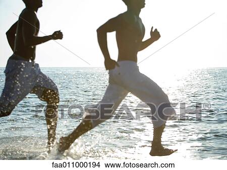 Two men running on beach View Large Photo Image Picture - Two men running on beach. Fotosearch
