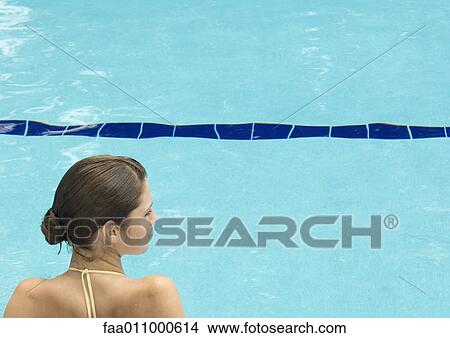 Woman by pool, head and shoulders, rear view View Large Photo Image Picture - Woman by pool, head and shoulders, rear view. Fotosearch