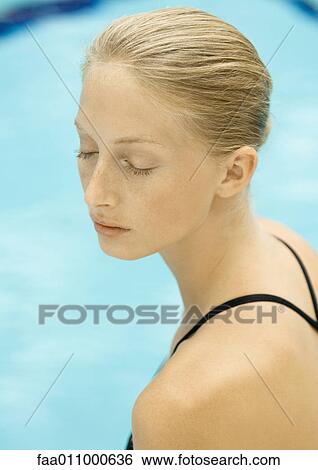 Woman, eyes closed, pool in background View Large Photo Image Stock Photograph - Woman, eyes closed, pool in background. Fotosearch