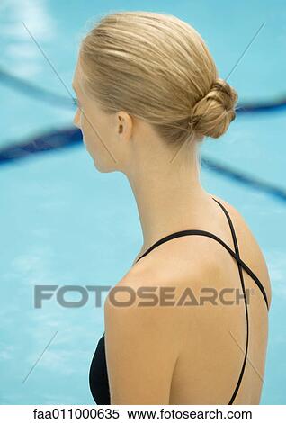 Woman in bathing suit, looking at swimming pool, side view View Large Photo Image Stock Photography - Woman in bathing suit, looking at swimming pool, side view. Fotosearch
