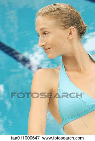 Woman in bikini sitting by pool View Large Photo Image Stock Photo - Woman in bikini sitting by pool. Fotosearch