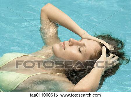 Woman in pool, head back and hands in hair with eyes closed View Large Photo Image Stock Photography - Woman in pool, head back and hands in hair with eyes closed. Fotosearch