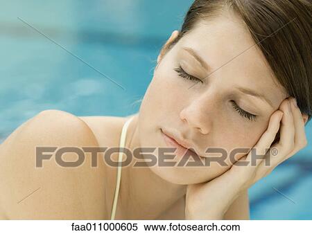 Woman lounging by pool, eyes closed View Large Photo Image Stock Photography - Woman lounging by pool, eyes closed. Fotosearch
