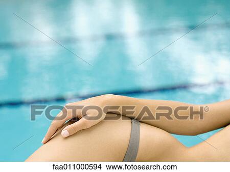 Woman lounging by side of pool, close-up of hip View Large Photo Image Picture - Woman lounging by side of pool, close-up of hip. Fotosearch