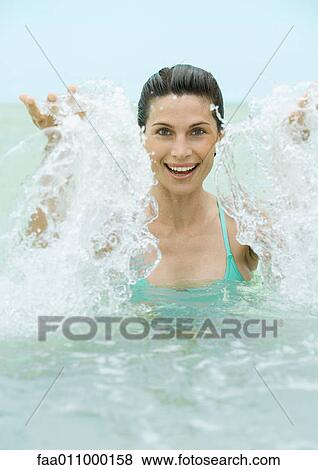 Stock Photo - Woman splashing in water. Fotosearch