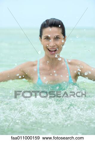 Woman splashing in water View Large Photo Image Stock Photo - Woman splashing in water. Fotosearch