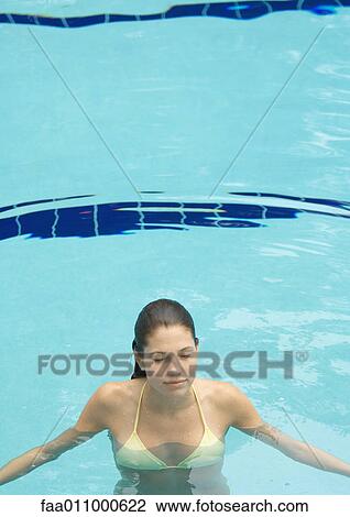 Woman standing in pool, eyes closed, front view View Large Photo Image Stock Image - Woman standing in pool, eyes closed, front view. Fotosearch