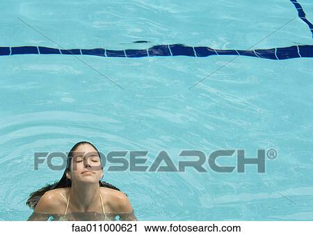 Woman standing in pool, head back and eyes closed, front view View Large Photo Image Stock Image - Woman standing in pool, head back and eyes closed, front view. Fotosearch