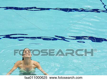 Woman standing in pool, head back and eyes closed, front view View Large Photo Image Stock Photography - Woman standing in pool, head back and eyes closed, front view. Fotosearch