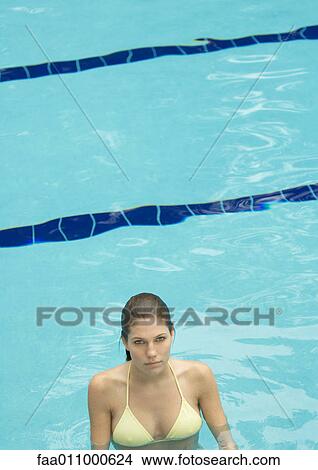 Woman standing in pool, looking at camera View Large Photo Image Picture - Woman standing in pool, looking at camera. Fotosearch
