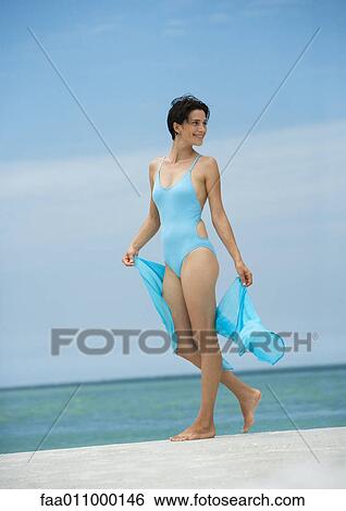 Woman standing on beach View Large Photo Image Stock Photograph - Woman standing on beach. Fotosearch