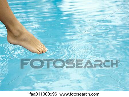 Woman touching surface of water with toe, close-up of foot and water View Large Photo Image Stock Photograph - Woman touching surface of water with toe, close-up of foot and water. Fotosearch