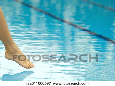 Woman's foot dangling over surface of pool View Large Photo Image Stock Photo - Woman's foot dangling over surface of pool. Fotosearch