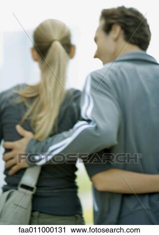 Stock Image - Young couple, rear view. Fotosearch