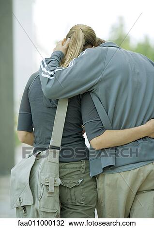 Young couple walking, rear view View Large Photo Image Stock Image - Young couple walking, rear view. Fotosearch