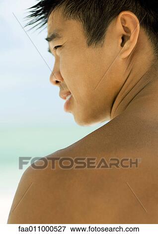 Young man, profile, sea in background View Large Photo Image Stock Photo - Young man, profile, sea in background. Fotosearch