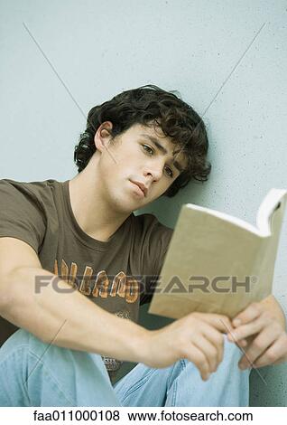 Stock Photo - Young man reading book. Fotosearch