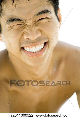 Stock Image - Young man squinting. Fotosearch
