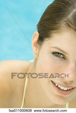 Young woman by pool, smiling, portrait View Large Photo Image Stock Photo - Young woman by pool, smiling, portrait. Fotosearch