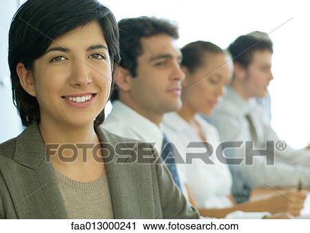 Business colleagues having meeting, focus on woman in foreground View Large Photo Image Stock Image - Business colleagues having meeting, focus on woman in foreground. Fotosearch