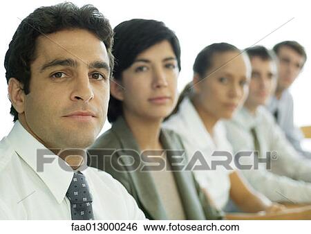 Business colleagues having meeting, focus on man in foreground View Large Photo Image Stock Photograph - Business colleagues having meeting, focus on man in foreground. Fotosearch