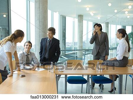 Business colleagues standing, discussing View Large Photo Image Stock Image - Business colleagues standing, discussing . Fotosearch