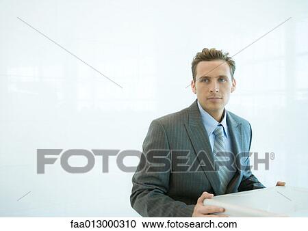 Businessman, about to open briefcase View Large Photo Image Stock Image - Businessman, about to open briefcase. Fotosearch