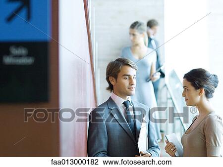Businessman and woman talking View Large Photo Image Stock Image - Businessman and woman talking. Fotosearch