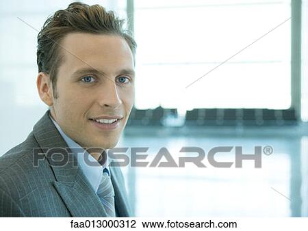 Stock Image - Businessman, portrait in airport. Fotosearch