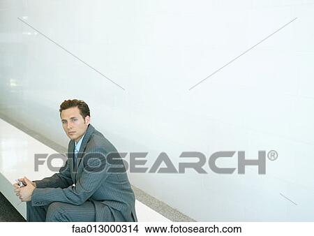 Picture - Businessman sitting on bench. Fotosearch