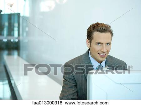 Businessman sitting on bench with open briefcase, smiling View Large Photo Image Stock Photo - Businessman sitting on bench with open briefcase, smiling. Fotosearch