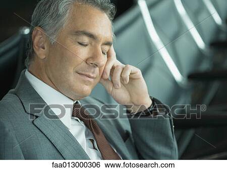 Businessman sleeping in airport lounge View Large Photo Image Stock Photograph - Businessman sleeping in airport lounge. Fotosearch